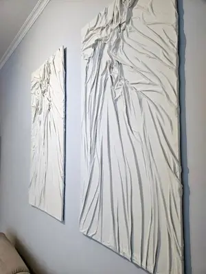 two pieces of art hanging on a wall at Gallo 55 Stylish & Modern Stay Near the Vatican in Rome