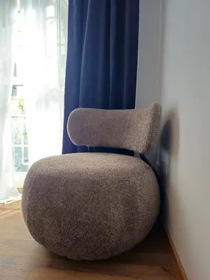 a chair sitting in a room with a blue curtain at Gallo 55 Stylish & Modern Stay Near the Vatican in Rome
