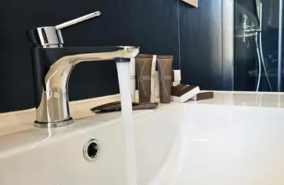a bathroom sink with a faucet on top of it at Gallo 55 Stylish & Modern Stay Near the Vatican in Rome
