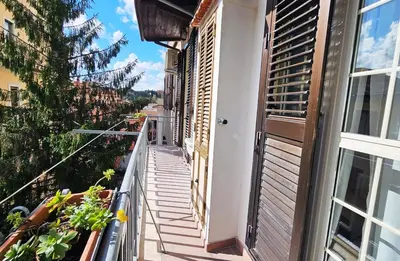 a balcony of a building with plants and a window at Gallo 55 Stylish & Modern Stay Near the Vatican in Rome