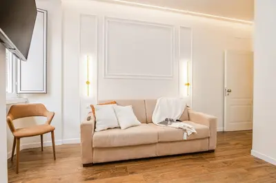 a living room with a couch and a chair at IV Leoni in Rome