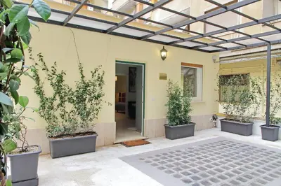 a patio with three potted plants in pots at Gioia's Flat in Rome