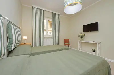 a bedroom with a large bed and a television at Gioia's Flat in Rome