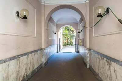 an empty hallway with an archway in a building at iFlat Mid-Century Modern Vatican Apartment in Rome