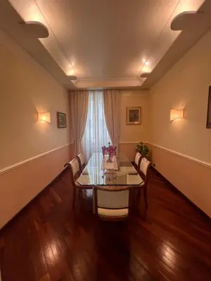 a dining room with a table and chairs and a window at Residenza Lucullo in Rome