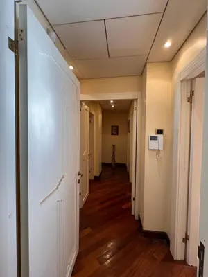 an empty hallway with white doors and wood floors at Residenza Lucullo in Rome