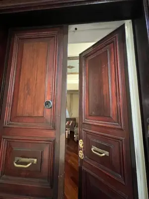 two wooden doors in a room with a hallway at Residenza Lucullo in Rome
