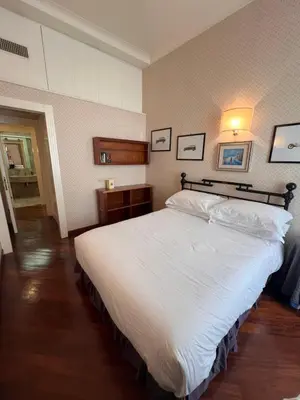 a bedroom with a large white bed in it at Residenza Lucullo in Rome