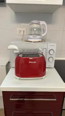 a red toaster sitting on top of a kitchen counter at Betterplace 2 in Rome