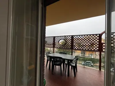 a table and chairs on a balcony with a view at Charm Apartment & Relax Jacuzzi Roma-Gemelli in Rome