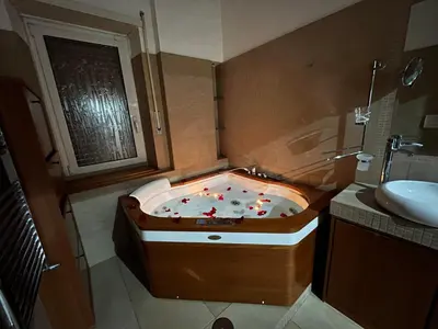 a bathroom with a jacuzzi tub with a sink at Charm Apartment & Relax Jacuzzi Roma-Gemelli in Rome