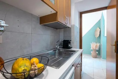 a kitchen with a bowl of fruit on the counter at Botanico 24 Apt - Homkeey Apartments in Rome