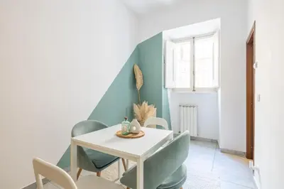 a dining room with a white table and chairs at Botanico 24 Apt - Homkeey Apartments in Rome