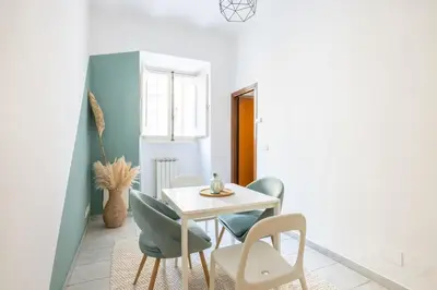 a dining room with a white table and chairs at Botanico 24 Apt - Homkeey Apartments in Rome