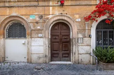 an old building with a wooden door and two windows at Botanico 24 Apt - Homkeey Apartments in Rome