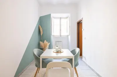 a dining room with a white table and chairs at Botanico 24 Apt - Homkeey Apartments in Rome