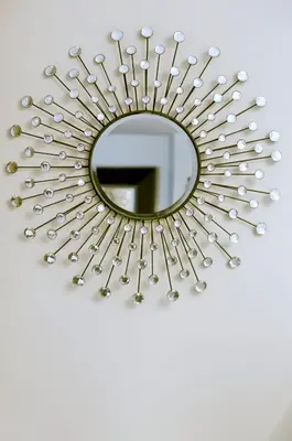 a mirror hanging on a wall with silver screws at Hotel Valeri in Rome