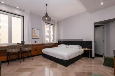a bedroom with a bed and a table and chairs at Hotel Valeri in Rome