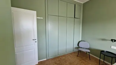 a room with a white door and a chair at Casa Vista San Pietro in Rome