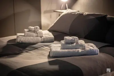 two towels sitting on top of a bed at Luxury House in Roma Nicolo V 120 mq in Rome