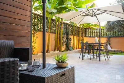 a patio with an umbrella and a table and chairs at Luxury House in Roma Nicolo V 120 mq in Rome