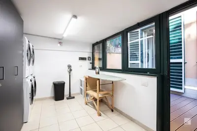 a kitchen with a table and a refrigerator at Luxury House in Roma Nicolo V 120 mq in Rome