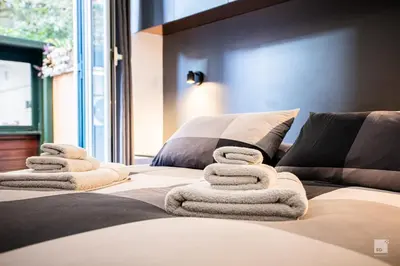 a bed with folded towels on top of it at Luxury House in Roma Nicolo V 120 mq in Rome