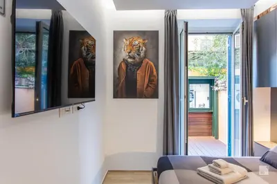 a bedroom with two paintings of tigers on the wall at Luxury House in Roma Nicolo V 120 mq in Rome