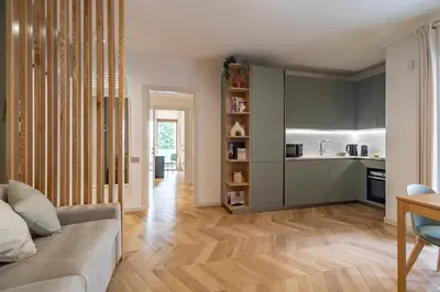 a living room with a couch and a kitchen at AureaLiving - Sage luxury apt with Air Conditioning, Fast Wifi and free Gym in Rome