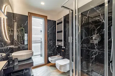 a bathroom with a sink and a toilet and a shower at AureaLiving - Sage luxury apt with Air Conditioning, Fast Wifi and free Gym in Rome