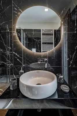 a bathroom with a white sink and a mirror at AureaLiving - Sage luxury apt with Air Conditioning, Fast Wifi and free Gym in Rome