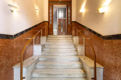 a set of stairs in a building with a door at NOH Vatican Courtyard in Rome