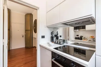 a kitchen with white cabinets and a stove at The Best Rent - One-bedroom apartment in a quiet, classically styled corner near the Quirinale in Rome