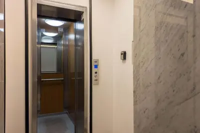 a elevator in a building with a glass door at The Best Rent - One-bedroom apartment in a quiet, classically styled corner near the Quirinale in Rome