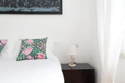 a bedroom with a bed and a nightstand with a lamp at YCH-Nice flat with patio near Vatican in Rome