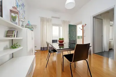 a dining room with a glass table and chairs at YCH-Nice flat with patio near Vatican in Rome