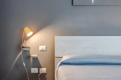 a bedroom with a bed with a lamp next to it at Primavera Home in Rome