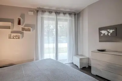 a white bedroom with a bed and a window at Primavera Home in Rome