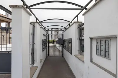 an alleyway between two buildings with wrought iron gates at Primavera Home in Rome