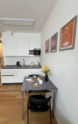 a small kitchen with a table and a counter top at GioLu Colosseo in Rome
