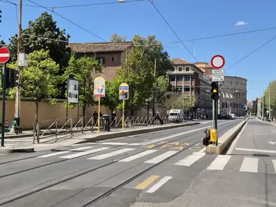 an empty street with a traffic light on a city street at GioLu Colosseo in Rome