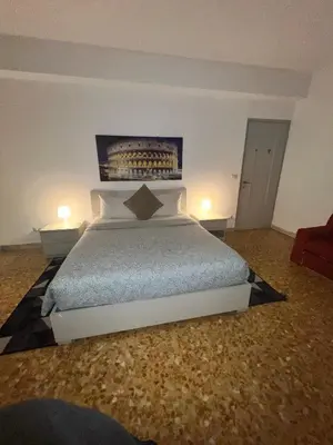 a bedroom with a bed with two tables and two lamps at Centro Metro Montitiburtini 510 in Rome