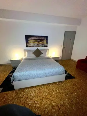 a bedroom with a large bed with two lamps at Centro Metro Montitiburtini 510 in Rome