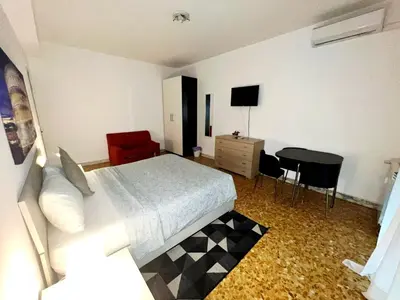 a bedroom with a bed and a table and a desk at Centro Metro Montitiburtini 510 in Rome