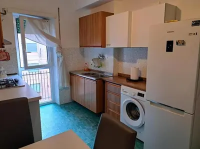 a kitchen with a refrigerator and a washing machine at Centro Metro Montitiburtini 510 in Rome