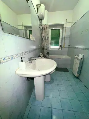 a bathroom with a sink and a mirror and a tub at Centro Metro Montitiburtini 510 in Rome