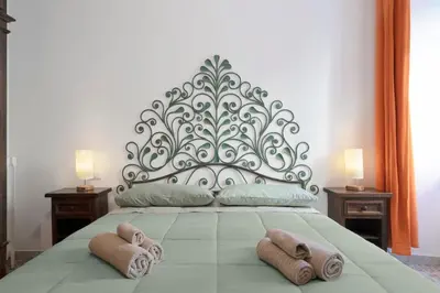 a bedroom with a large bed with towels on it at Angels Beauty House in Rome