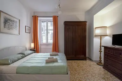 a bedroom with a bed and a television and a window at Angels Beauty House in Rome