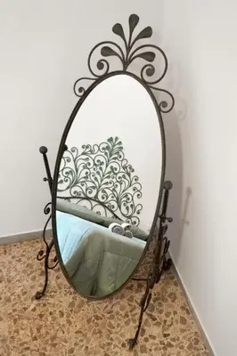 a mirror with a wrought iron frame on a wall at Angels Beauty House in Rome