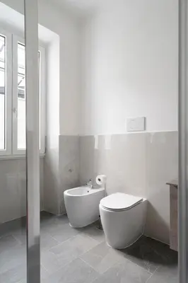 a bathroom with a toilet and a tub and a sink at Angels Beauty House in Rome